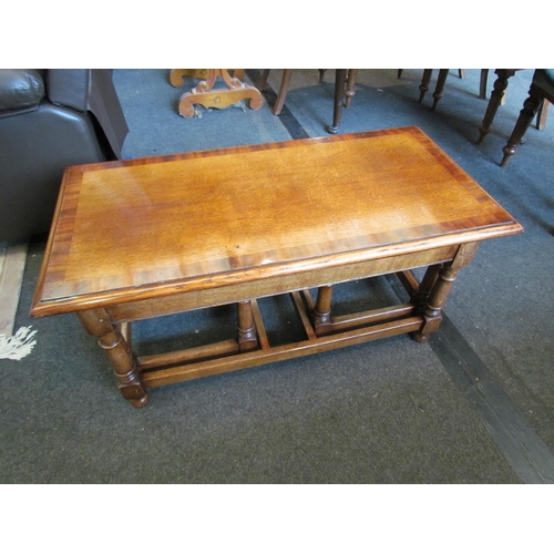 1117 - A Jacobean style crossbanded oak nest of three coffee tables, largest 45cm tall x 91cm long x 45cm w... 