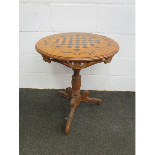 1121 - A circular top games table on carved column to tripod legs, 70cm tall x 56cm diameter