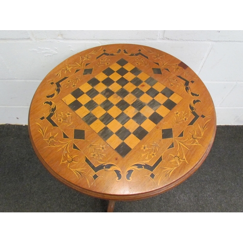 1121 - A circular top games table on carved column to tripod legs, 70cm tall x 56cm diameter