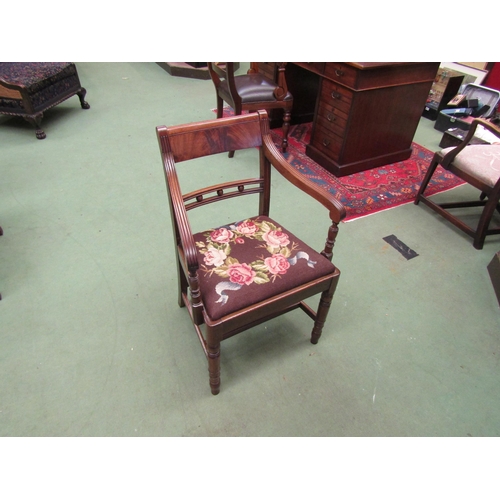 4002 - A George III flame mahogany Suffolk ball back armchair, the reeded arms on turned supports and fore ... 