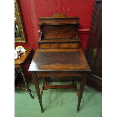 4052 - An Edwardian inlaid rosewood writing desk, the raised shelf back and two drawers over a hinged fall ... 