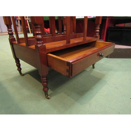 4146 - A George III style mahogany three division Canterbury with turned supports over a single base drawer... 