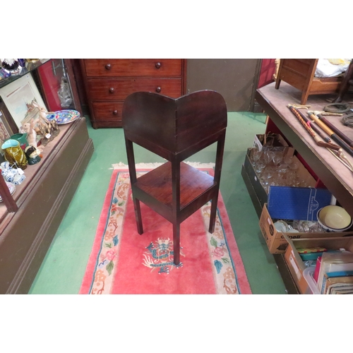 4173 - A George III mahogany two tier gentleman's corner washstand, the raised back over bowl recesses on s... 