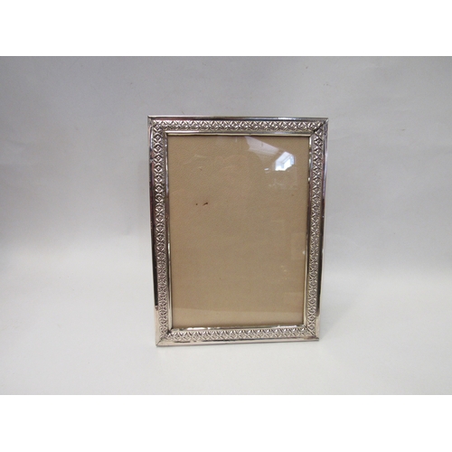 4392 - A Middle Eastern silver photograph frame, floral and foliage relief frame, 24cm x 18cm, with origina... 