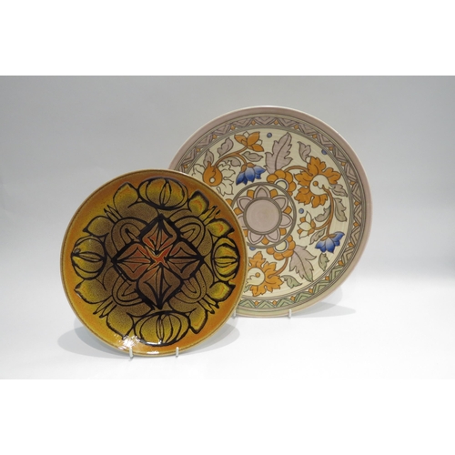 4012 - A Charlotte Rhead Crown Ducal charger, 32cm diameter, and a Poole plate, 24cm diameter (2)  (R)  £45