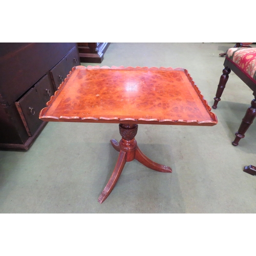 4016 - A reproduction walnut tripod wine table, rectangular tray top with wavy edge, over a carved column t... 