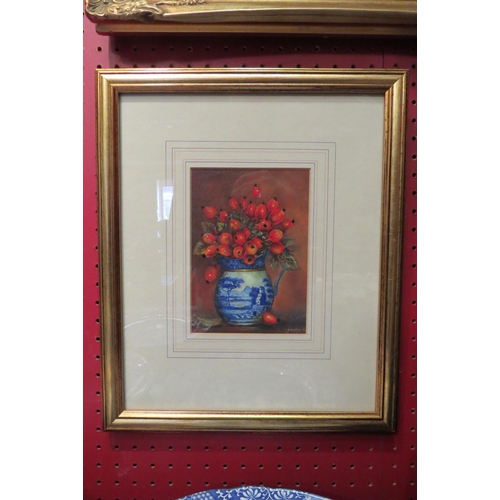 4025 - JAMES J. ALLEN: A coloured print with overpainting depicting rosehips in a blue and white jug, frame... 