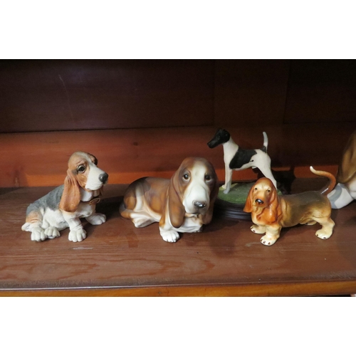 4034 - Seven dog figures, bisque Bassets, resin example, hand painted Fox Terrier on stand