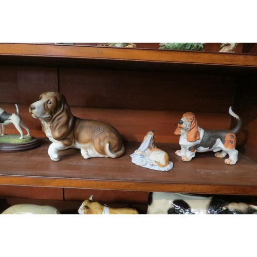 4034 - Seven dog figures, bisque Bassets, resin example, hand painted Fox Terrier on stand