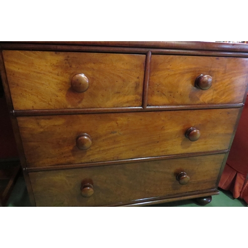 4056 - A Circa 1840 flame mahogany chest of two short over two long drawers with turned bun handles and hal... 