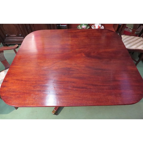 4061 - A George III round cornered tilt-top mahogany table over a turned column and reeded tri-leg base on ... 