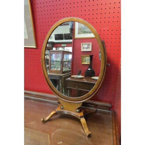 4072 - A Georgian style dressing table oval mirror on a scroll foot base with brass stud decoration, 51.5cm... 