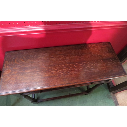 4079 - A circa 1920 oak hall table the single frieze drawer over turned cannon barrel legs united by chamfe... 