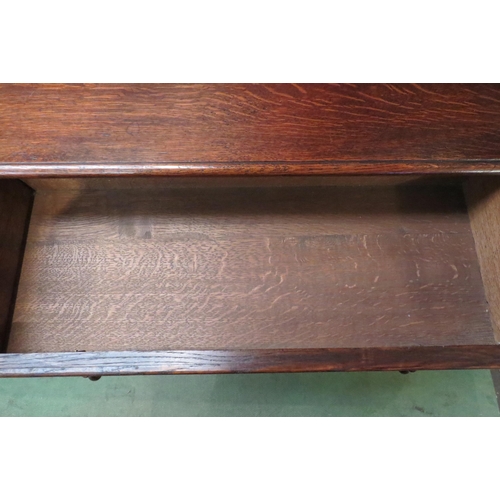 4079 - A circa 1920 oak hall table the single frieze drawer over turned cannon barrel legs united by chamfe... 