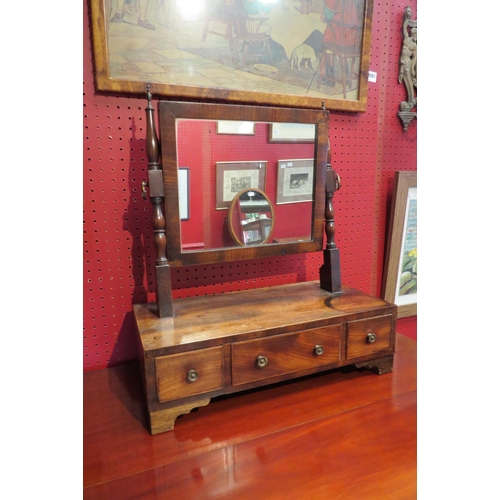 4083 - A 19th Century mahogany toilet mirror, turned supports with brass finials, three drawer base to brac... 