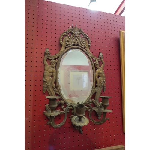 4085 - A brassed effect triple girandole mirror with candle sconces, 44cm tall x 27cm wide