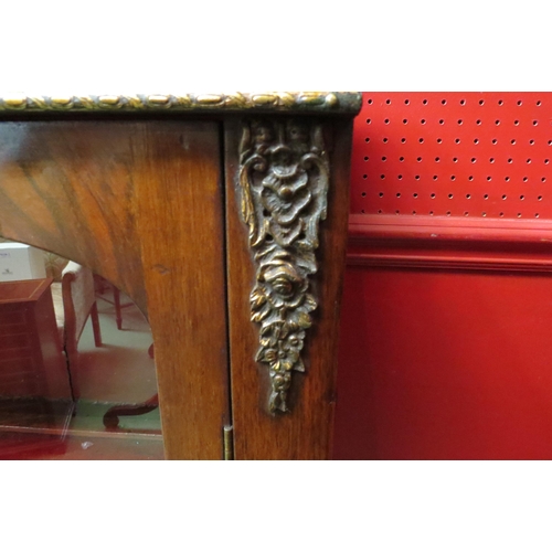 4116 - A Victorian inlaid walnut pier cabinet/bookcase with brass ormolu mounts, the two arched doors with ... 