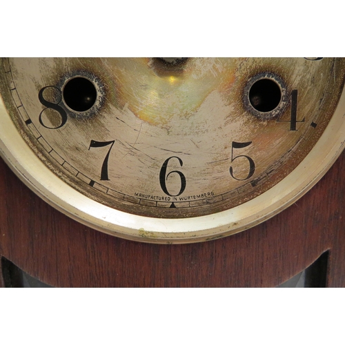 4130 - An oak cased arch top mantel clock marked Wurtemberg to dial, with key and pendulum