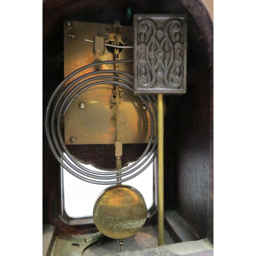 4130 - An oak cased arch top mantel clock marked Wurtemberg to dial, with key and pendulum