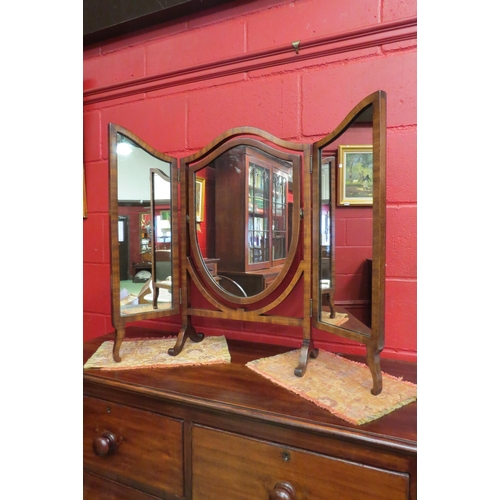 4138 - An Edwardian mahogany shield shape triptych dressing chest mirror on an arched scroll foot base, 71.... 