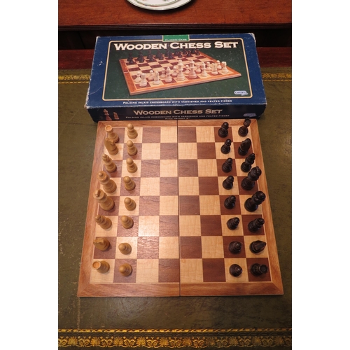 4166 - A boxed Gibsons chess set.  Inlaid wood board, wooden pieces.  Board - 36cm x 36cm.  King height - 7... 