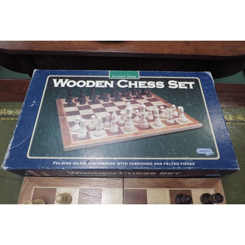 4166 - A boxed Gibsons chess set.  Inlaid wood board, wooden pieces.  Board - 36cm x 36cm.  King height - 7... 