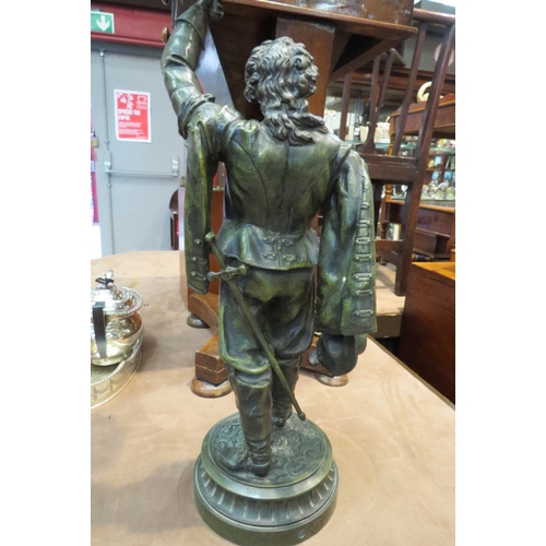 4190 - A French reproduction bronzed figural table lamp in the form of a musketeer holding a flame shade al... 