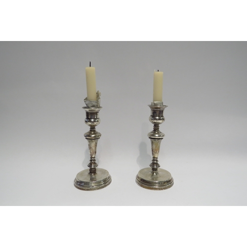 4382 - A pair of weighted silver candlesticks, London 1914, 17cm high a/f