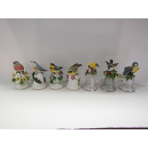 4237 - Four Franklin Mint ceramic bell's surmounted by birds and three similar glass examples