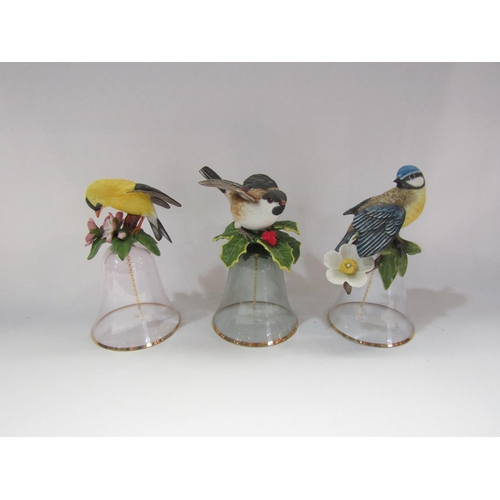 4237 - Four Franklin Mint ceramic bell's surmounted by birds and three similar glass examples