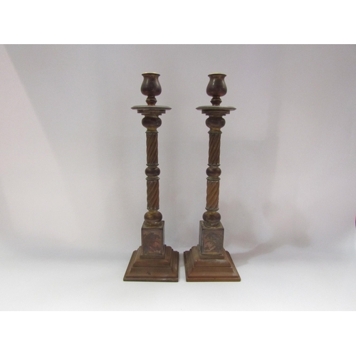 4257 - A pair of brass wrythen form candlesticks on square moulded step bases together with two 20th Centur... 