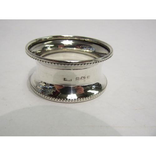 4289 - A silver sugar bowl, Birmingham, a sugar sifter with matched silver lid and a silver napkin ring (3)