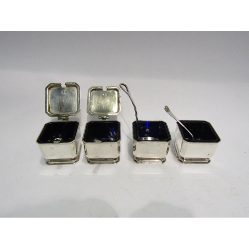 4297 - A silver condiment set, Birmingham, square form, blue glass liners and two pepperettes plus four ass... 