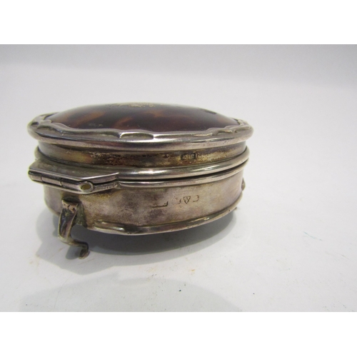 4301 - A circular silver trinket box, tortoiseshell set lid with applied dragon and initials to centre, on ... 