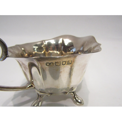 4319 - A silver cream jug and sugar bowl, fluted form with wavy edge rim.  Sugar bowl on pad feet