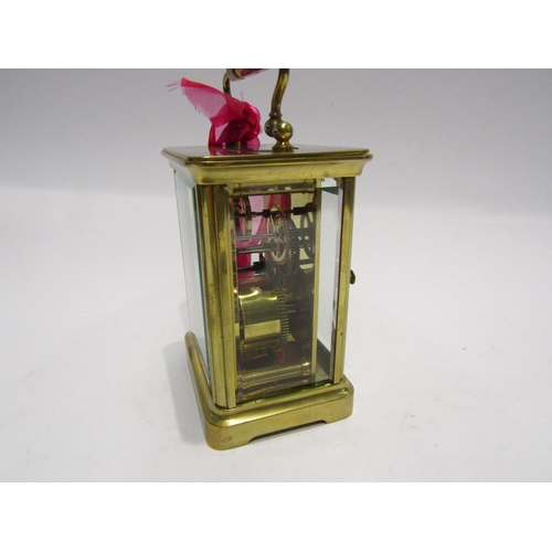 4321 - A brass cased carriage clock with key.  Bevelled glass side and door panels   (R) £40