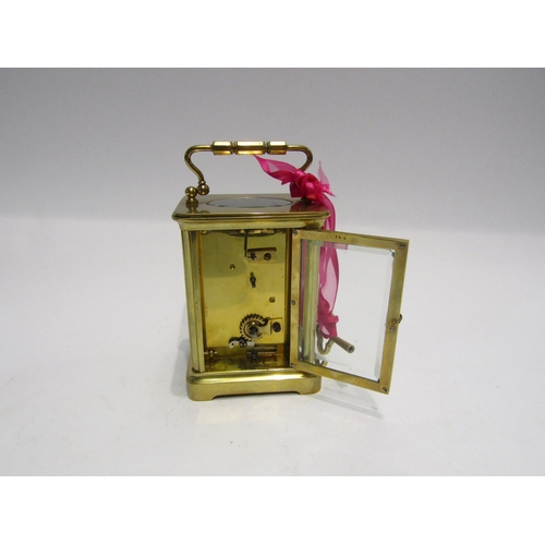 4321 - A brass cased carriage clock with key.  Bevelled glass side and door panels   (R) £40