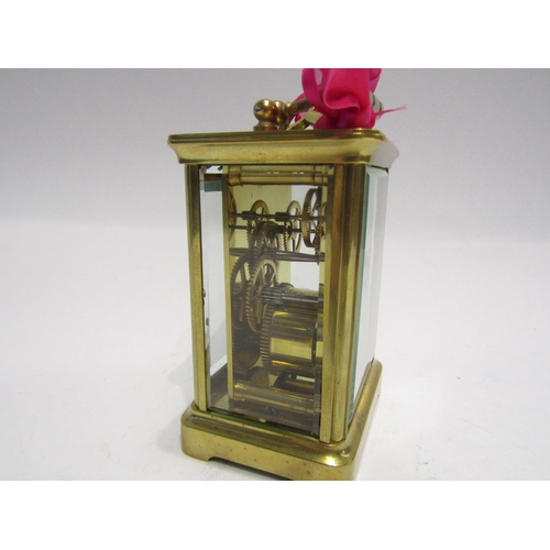 4321 - A brass cased carriage clock with key.  Bevelled glass side and door panels   (R) £40