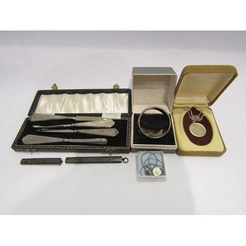 4330 - A group of silver and white metal, napkin ring, vanity set, pencil holders, pendant on chain