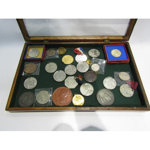 4333 - A display case containing a collection of Coronation and Death medals from George IV, Victoria to El... 