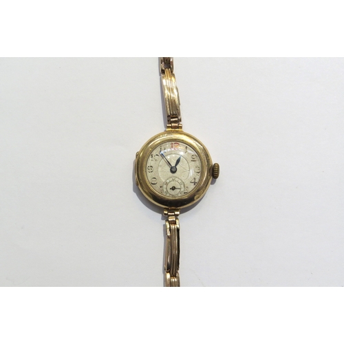 8128 - A 9ct gold ladies wristwatch with gold flexible sprung strap swiss movement