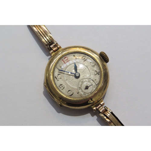 8128 - A 9ct gold ladies wristwatch with gold flexible sprung strap swiss movement