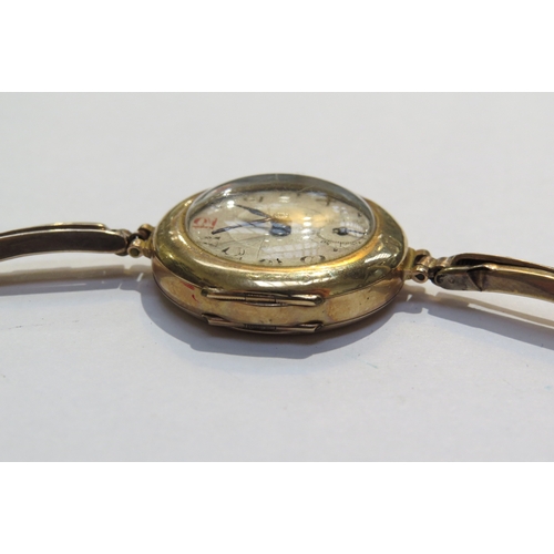 8128 - A 9ct gold ladies wristwatch with gold flexible sprung strap swiss movement