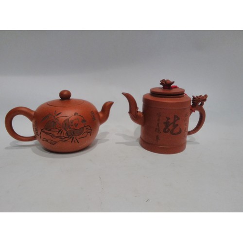 4417 - Two small Oriental teapots with character marks, one decorated with a Panda