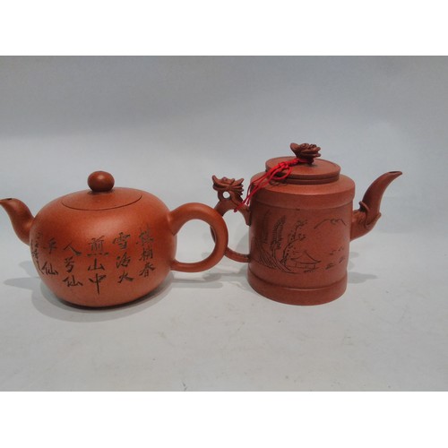 4417 - Two small Oriental teapots with character marks, one decorated with a Panda