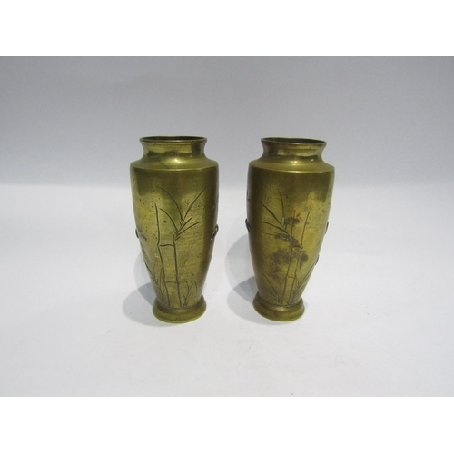 4388 - A pair of brass vases, Chinese influence with bird and flowers in relief, 16cm tall, one a/f, 15cm t... 