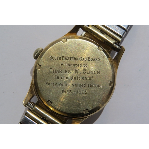 8110 - A Garrad retailed 9ct gold cased gents manual wind wristwatch. Presentation inscription to back on b... 