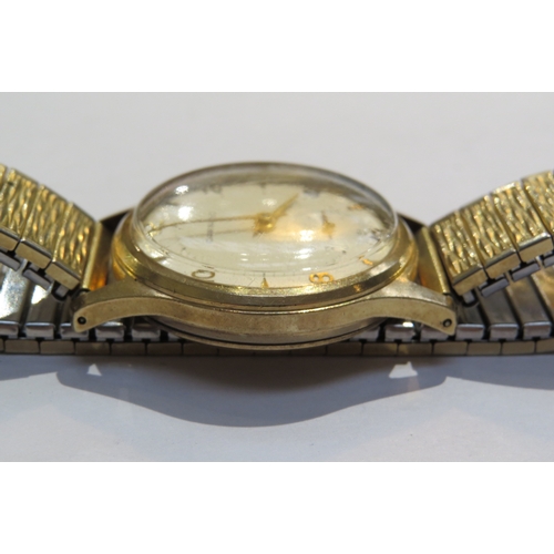 8110 - A Garrad retailed 9ct gold cased gents manual wind wristwatch. Presentation inscription to back on b... 