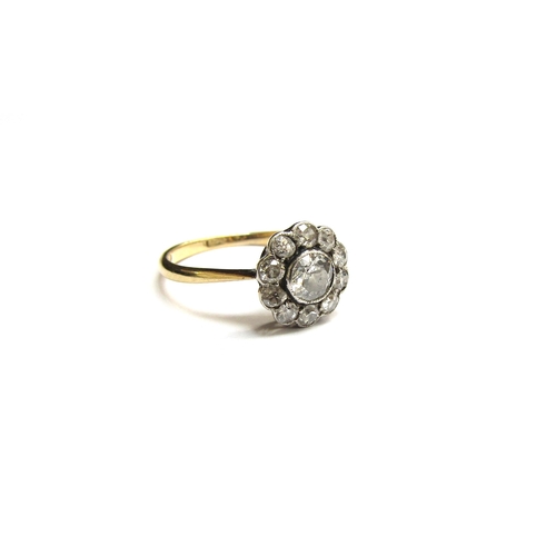 9299 - A diamond daisy ring, 10mm diameter, marks rubbed. Size K, 2g