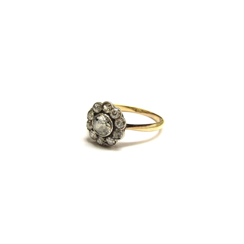 9299 - A diamond daisy ring, 10mm diameter, marks rubbed. Size K, 2g